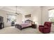 Large main bedroom with plush carpet, ceiling fan, sitting area, and bright natural light at 1432 Kinnard Cir, Ormond Beach, FL 32174