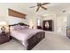Spacious main bedroom with ceiling fan, en-suite bathroom, and comfortable carpet at 1432 Kinnard Cir, Ormond Beach, FL 32174