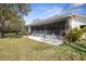 Outdoor patio area with a dining set and landscaped yard at 1432 Kinnard Cir, Ormond Beach, FL 32174