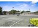 Well-kept tennis courts with a shelter and tennis ball cart in the foreground for community recreation at 1432 Kinnard Cir, Ormond Beach, FL 32174