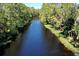 Tranquil waterway bordered by lush green trees and vegetation at 1432 Kinnard Cir, Ormond Beach, FL 32174