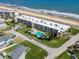 Aerial view of condo with a pool near the beach offers luxurious coastal living with an amazing ocean view at 2600 Ocean Shore Blvd # 103, Ormond Beach, FL 32176