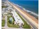 Beautiful aerial view of a beachside property with a pool, pristine beachfront, and stunning ocean views at 2600 Ocean Shore Blvd # 103, Ormond Beach, FL 32176