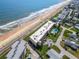 Aerial view of oceanfront condos with a shared pool, private parking and easy beach access at 2600 Ocean Shore Blvd # 103, Ormond Beach, FL 32176