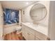 Bathroom boasts blue accents, a large vanity and a tiled shower at 2600 Ocean Shore Blvd # 103, Ormond Beach, FL 32176