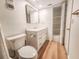 Well-lit bathroom features modern vanity, storage and wood-look floors at 2600 Ocean Shore Blvd # 103, Ormond Beach, FL 32176