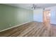 Inviting bedroom features modern ceiling fan, wood-look floors, and connects to a stylish bathroom at 2600 Ocean Shore Blvd # 103, Ormond Beach, FL 32176
