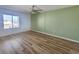 Spacious bedroom with modern ceiling fan, wood-look flooring and bright, sunny window at 2600 Ocean Shore Blvd # 103, Ormond Beach, FL 32176