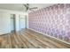 Laminate-floored bedroom with ceiling fan and closet storage at 2600 Ocean Shore Blvd # 103, Ormond Beach, FL 32176