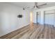 Bright, laminate-floored bedroom with closet and wall mounted TV at 2600 Ocean Shore Blvd # 103, Ormond Beach, FL 32176