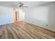 Sunlit bedroom with modern ceiling fan and wood-look flooring, providing ample space at 2600 Ocean Shore Blvd # 103, Ormond Beach, FL 32176