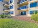 View of the building exterior featuring a patio overlooking a green lawn at 2600 Ocean Shore Blvd # 103, Ormond Beach, FL 32176
