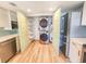 Kitchen with stainless steel appliances, and closet featuring a washer/dryer combo and shelving at 2600 Ocean Shore Blvd # 103, Ormond Beach, FL 32176