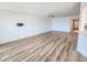 Open living area with ceiling fan, laminate floors, and white walls at 2600 Ocean Shore Blvd # 103, Ormond Beach, FL 32176