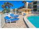 Lounge chairs and tables near the refreshing 3 ft 6 in. deep pool are perfect for relaxation at the condo at 2600 Ocean Shore Blvd # 103, Ormond Beach, FL 32176