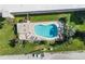 Aerial view of a private community pool featuring lounge chairs and beautiful landscaping at 2600 Ocean Shore Blvd # 103, Ormond Beach, FL 32176
