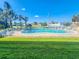 Community pool with lounge chairs offers a refreshing outdoor space for residents in a landscaped environment at 2600 Ocean Shore Blvd # 103, Ormond Beach, FL 32176