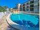 Community pool area with multiple lounge chairs and a bathroom is perfect for all residents at 2600 Ocean Shore Blvd # 103, Ormond Beach, FL 32176