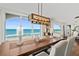 Dining room with ocean views, modern chandelier, and stylish decor at 3390 Ocean Shore Blvd # 4020, Ormond Beach, FL 32176