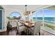 Elegant dining room with ocean views, a modern light fixture, and seating for six at 3390 Ocean Shore Blvd # 4020, Ormond Beach, FL 32176