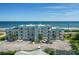 The exterior of the light blue condo building is captured from across the parking lot at 3390 Ocean Shore Blvd # 4020, Ormond Beach, FL 32176