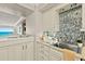 A bright kitchen includes stainless appliances and granite countertops, with ocean view beyond at 3390 Ocean Shore Blvd # 4020, Ormond Beach, FL 32176