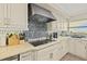 Bright kitchen features a stainless steel range hood over cooktop and stylish backsplash at 3390 Ocean Shore Blvd # 4020, Ormond Beach, FL 32176