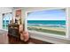 A coastal living room has hardwood floors and large windows that showcase ocean views at 3390 Ocean Shore Blvd # 4020, Ormond Beach, FL 32176