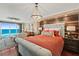 Bright main bedroom with wood accent wall, stylish chandelier, and stunning ocean views at 3390 Ocean Shore Blvd # 4020, Ormond Beach, FL 32176