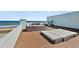 Relaxing rooftop deck with ocean views, outdoor seating, and sunbathing area at 3390 Ocean Shore Blvd # 4020, Ormond Beach, FL 32176