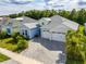 Aerial view of the home showcasing the roof, driveway, and landscaping at 753 Attitude Ave, Daytona Beach, FL 32124