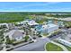 Aerial of the community center featuring a spacious outdoor area, dining options, and recreational facilities, all within lush landscaping at 753 Attitude Ave, Daytona Beach, FL 32124