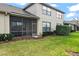 Spacious backyard showcasing the screened lanai and well-maintained lawn at 1320 Hansberry Ln, Ormond Beach, FL 32174