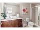 Bathroom with a clean white vanity, toilet, shower, and neutral-toned walls and fixtures at 1320 Hansberry Ln, Ormond Beach, FL 32174