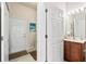 Bathroom featuring a vanity, toilet, and doorway leading to the laundry room at 1320 Hansberry Ln, Ormond Beach, FL 32174