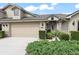 Charming home exterior featuring a two-car garage and well-maintained landscaping at 1320 Hansberry Ln, Ormond Beach, FL 32174