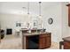 Kitchen view of breakfast bar and sink with stainless steel dual basin overlooking dining room, and matching pendant lighting at 1320 Hansberry Ln, Ormond Beach, FL 32174