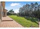 Spacious backyard with brick paver walkway and lush lawn, perfect for outdoor activities at 187 Indian Wells Ave, Kissimmee, FL 34759