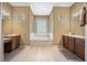 Bathroom with a soaking tub, double vanities, and hardwood floors at 187 Indian Wells Ave, Kissimmee, FL 34759