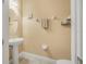 Charming powder room with pedestal sink, and neutral color palette at 187 Indian Wells Ave, Kissimmee, FL 34759