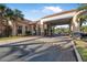 View of a building with a covered entrance and well-manicured landscaping at 187 Indian Wells Ave, Kissimmee, FL 34759