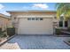 Spacious two-car garage with brick paver driveway and manicured landscaping at 187 Indian Wells Ave, Kissimmee, FL 34759