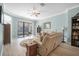 Bright living room with a ceiling fan and sliding glass doors leading to a screened porch at 187 Indian Wells Ave, Kissimmee, FL 34759