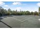 Exterior view of a tennis court with a tree line in the background at 187 Indian Wells Ave, Kissimmee, FL 34759