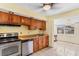 Efficient kitchen layout featuring light wood cabinets, appliances, and tile flooring at 24 River Dr, Ormond Beach, FL 32176