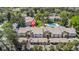 Aerial view of a condo community with mature trees, carports, and a community pool at 1 Tomoka Oaks Blvd # 112, Ormond Beach, FL 32174