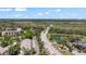 Scenic aerial view of the community with tree lined streets and its location near a serene lake and the ocean at 1 Tomoka Oaks Blvd # 112, Ormond Beach, FL 32174