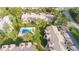 Aerial view of residential apartments and a swimming pool surrounded by mature landscaping and green space at 1 Tomoka Oaks Blvd # 112, Ormond Beach, FL 32174