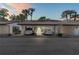 View of the covered carport with vehicles parked at dusk at 1 Tomoka Oaks Blvd # 112, Ormond Beach, FL 32174