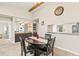 Inviting dining area with a wooden table, black chairs, and a view of the kitchen at 1 Tomoka Oaks Blvd # 112, Ormond Beach, FL 32174